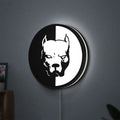 Pitbull Syndicate LED lightbox hanging on a wall with white glow