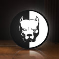 Front view of Pitbull Syndicate LED lightbox sign glowing on a wooden desk