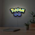 Pokemon GO LED lightbox hanging on a room wall with soft blue light