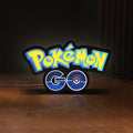 Front view of Pokemon GO LED lightbox sign glowing on a wooden desk