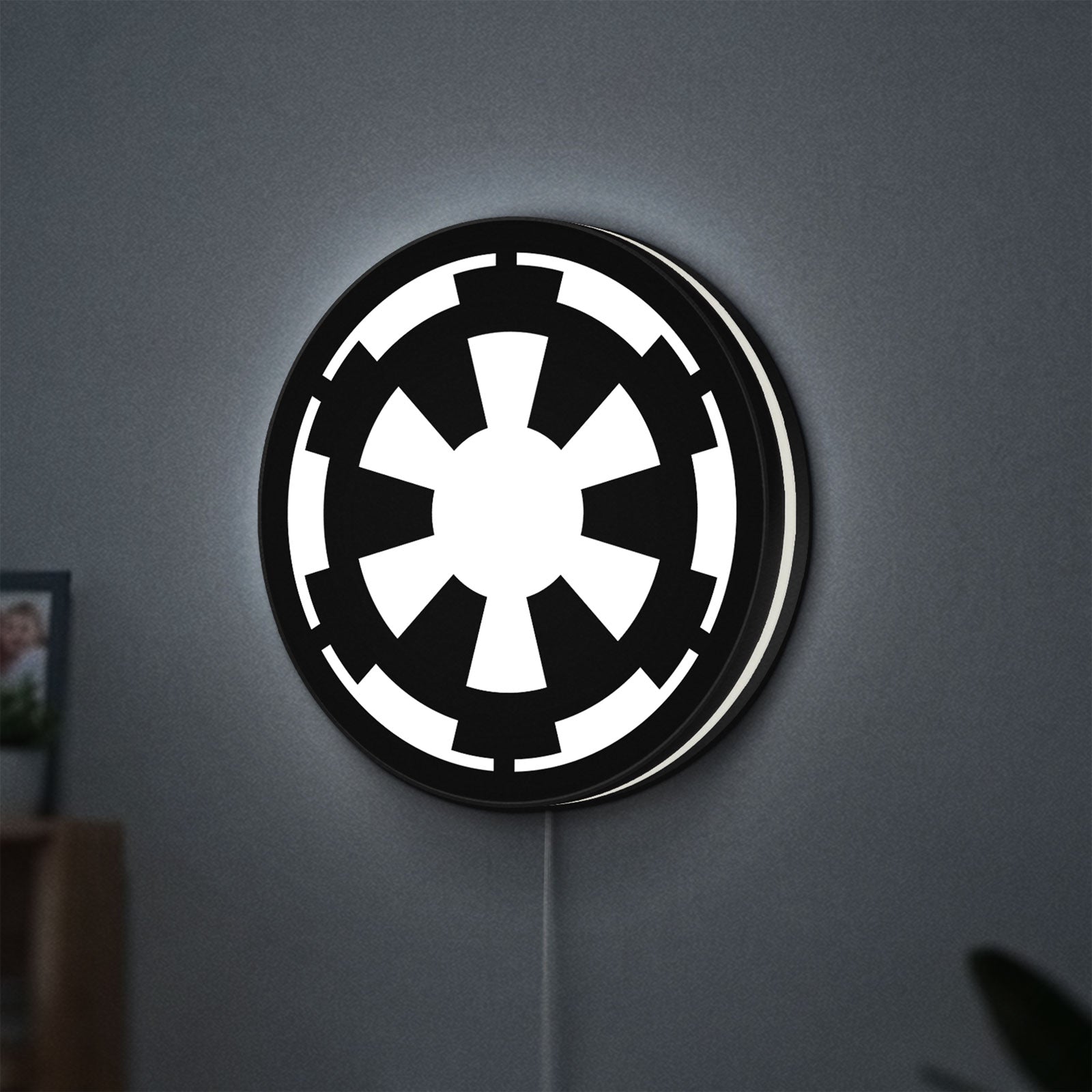 Galactic Empire LED lightbox hanging on a wall with white glow