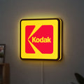 Kodak LED lightbox hanging on a wall with yellow glow