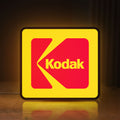 Front view of Kodak LED lightbox sign glowing on a wooden desk