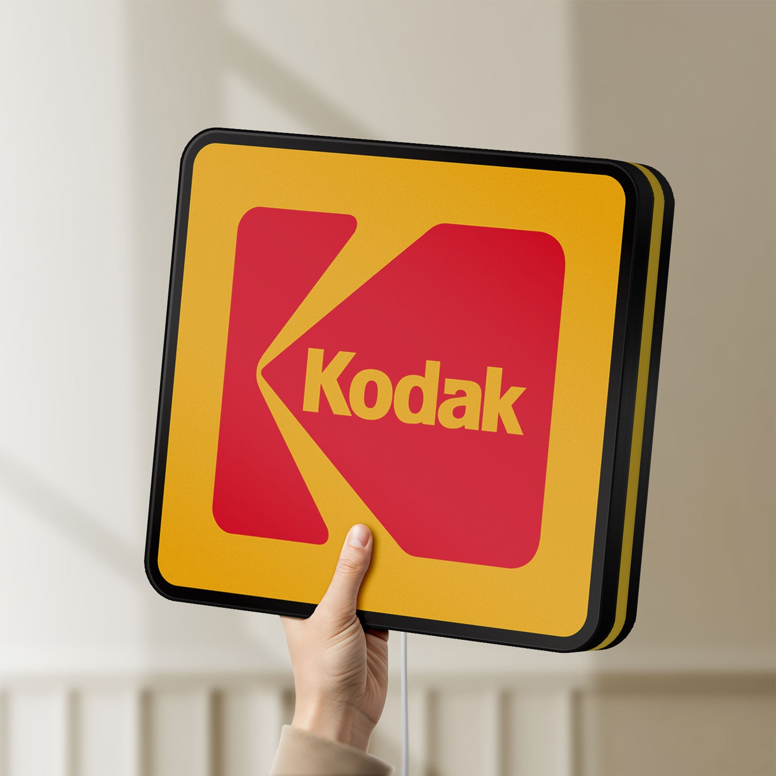 Unlit Kodak LED lightbox held by hand to show size and details