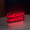 Mickey Mouse LED lightbox standing on a desk from an angled side view with red glow