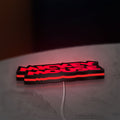 Mickey Mouse LED lightbox lying flat on a desk with red glow