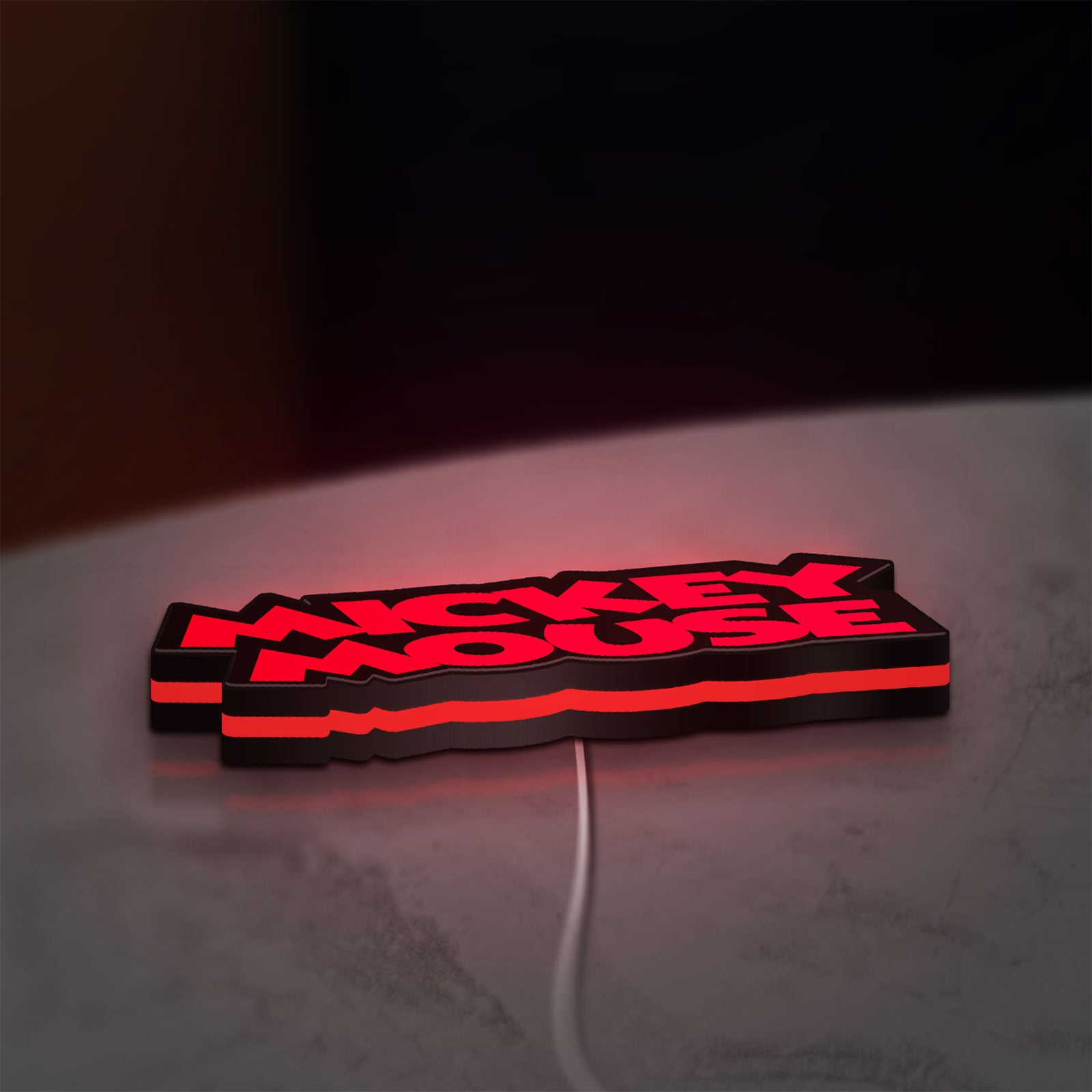 Mickey Mouse LED lightbox lying flat on a desk with red glow