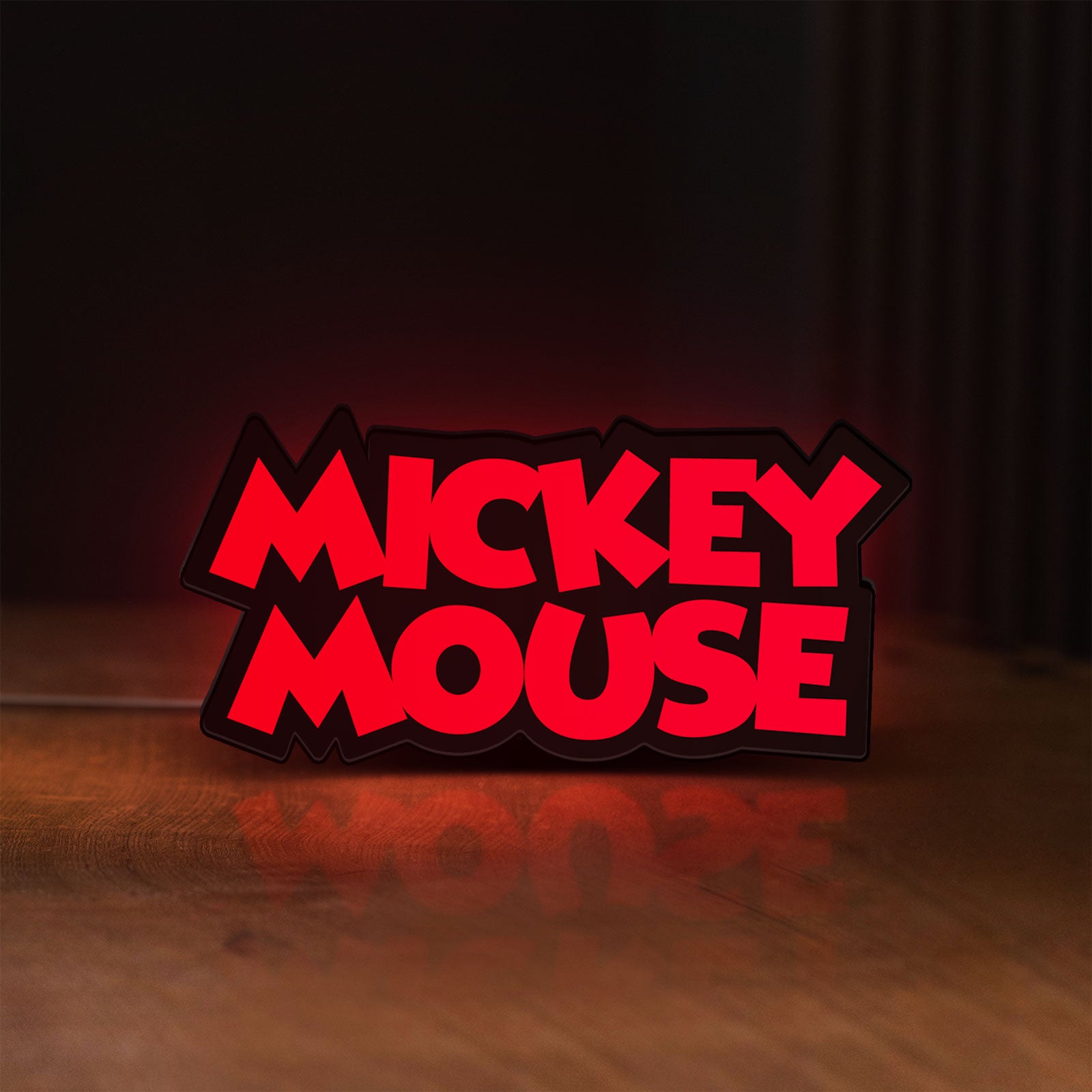 Front view of Mickey Mouse LED lightbox sign glowing on a wooden desk
