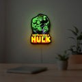 Hulk Smash Fist LED lightbox hanging on a room wall with soft green light