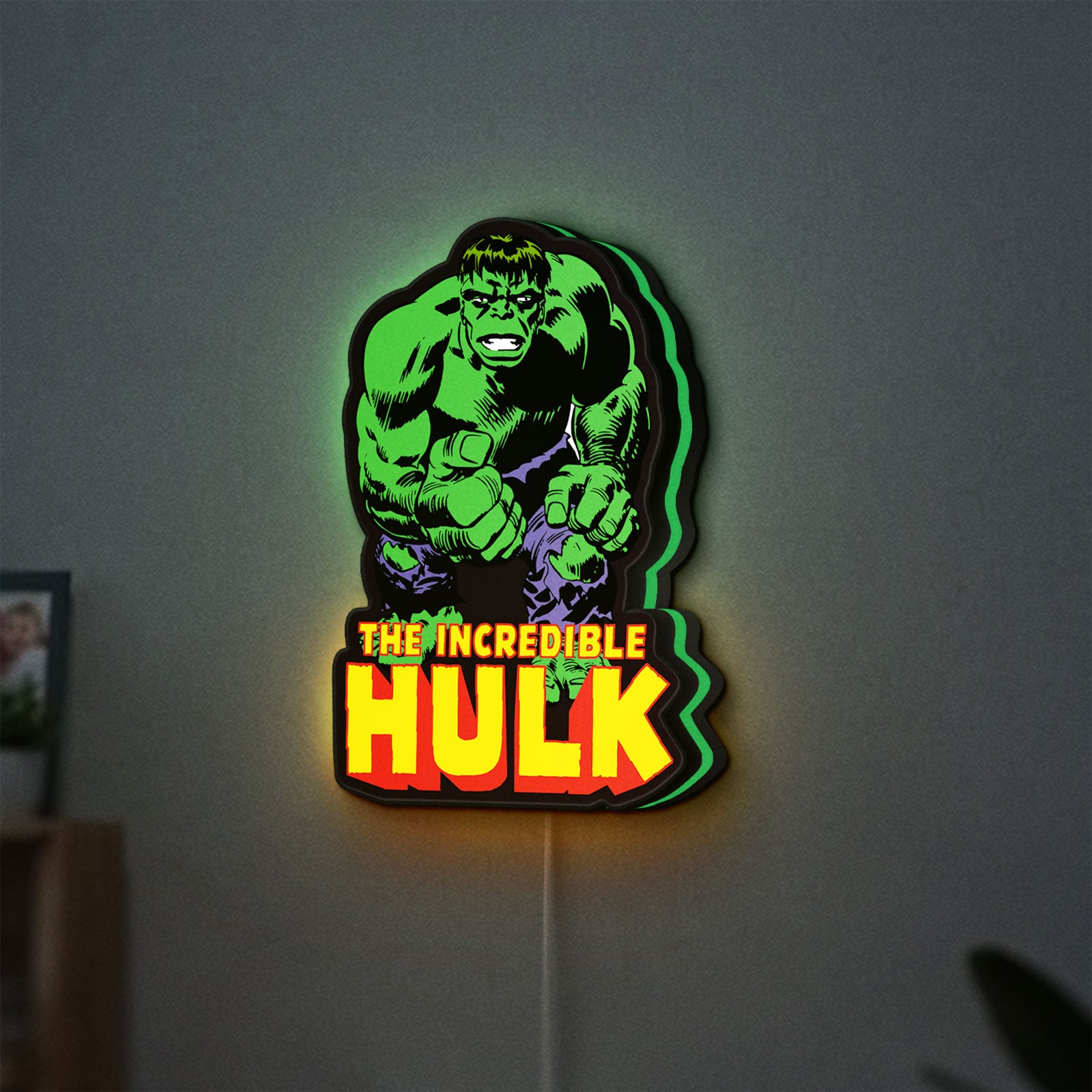 Hulk Smash Fist LED lightbox hanging on a wall with green glow