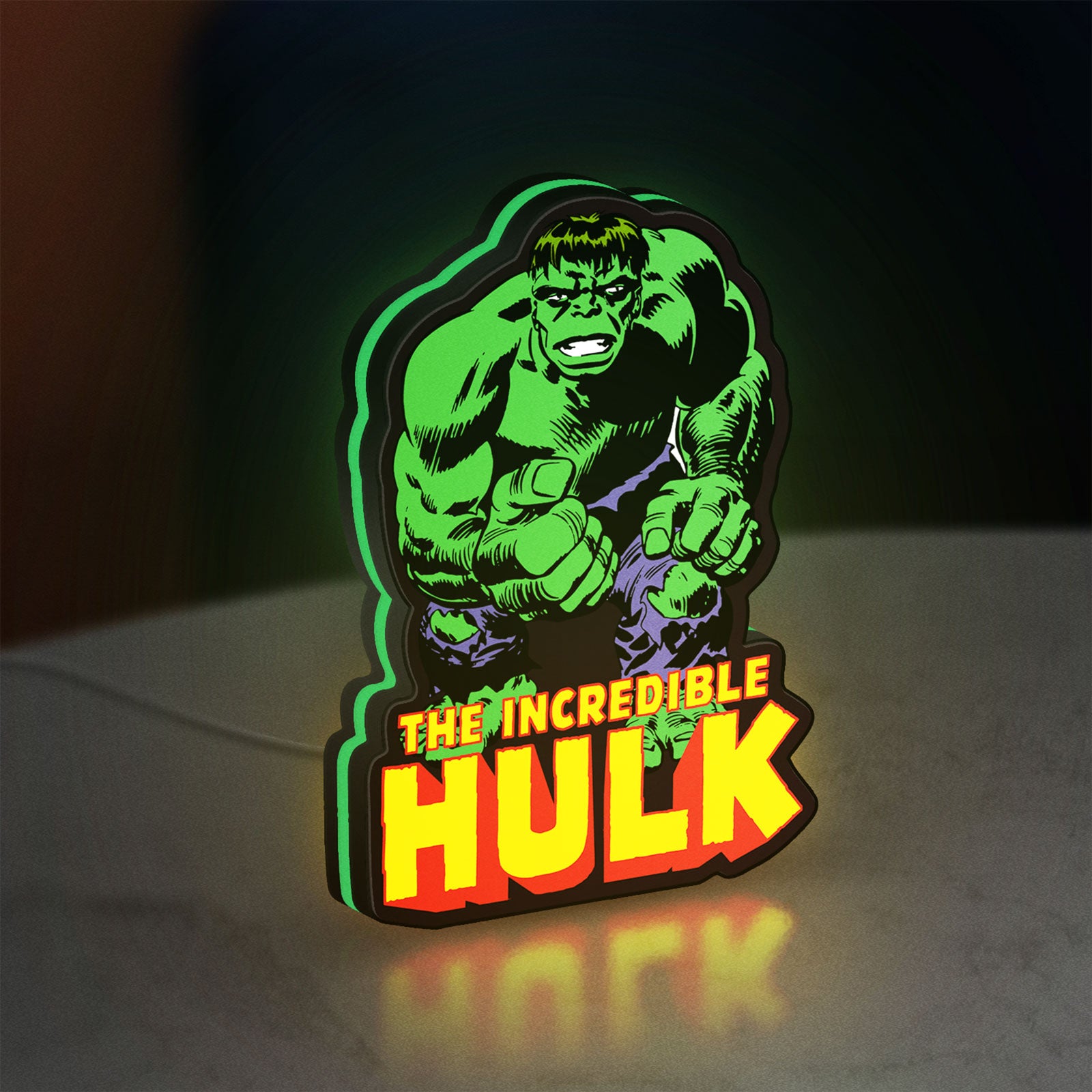 Hulk Smash Fist LED lightbox standing on a desk from an angled side view with green glow