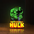 Front view of Hulk Smash Fist LED lightbox sign glowing on a wooden desk