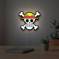 One Piece Skull LED lightbox hanging on a room wall with soft white light