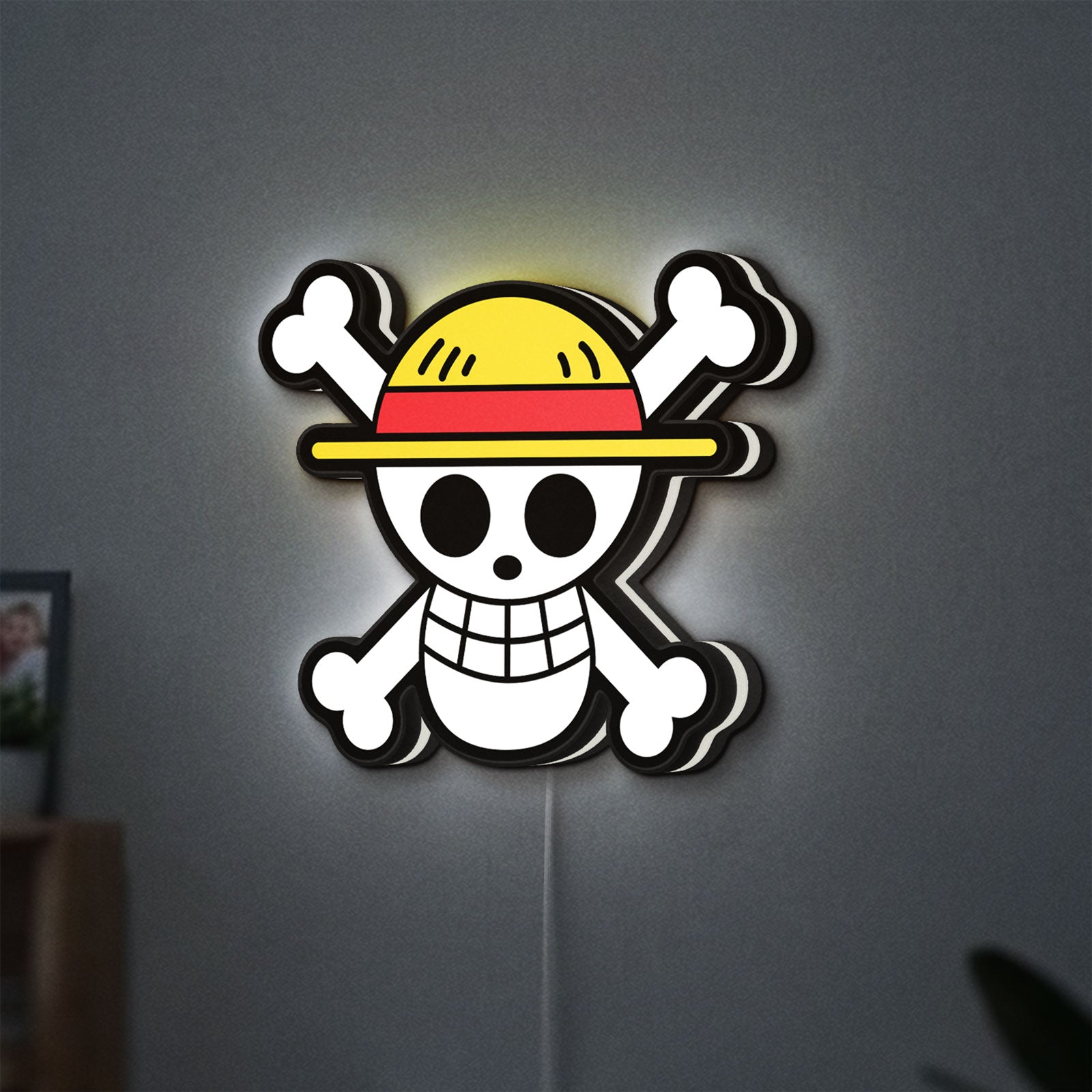 One Piece Skull LED lightbox hanging on a wall with white glow