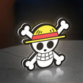 One Piece Skull LED lightbox standing on a desk from an angled side view with white glow