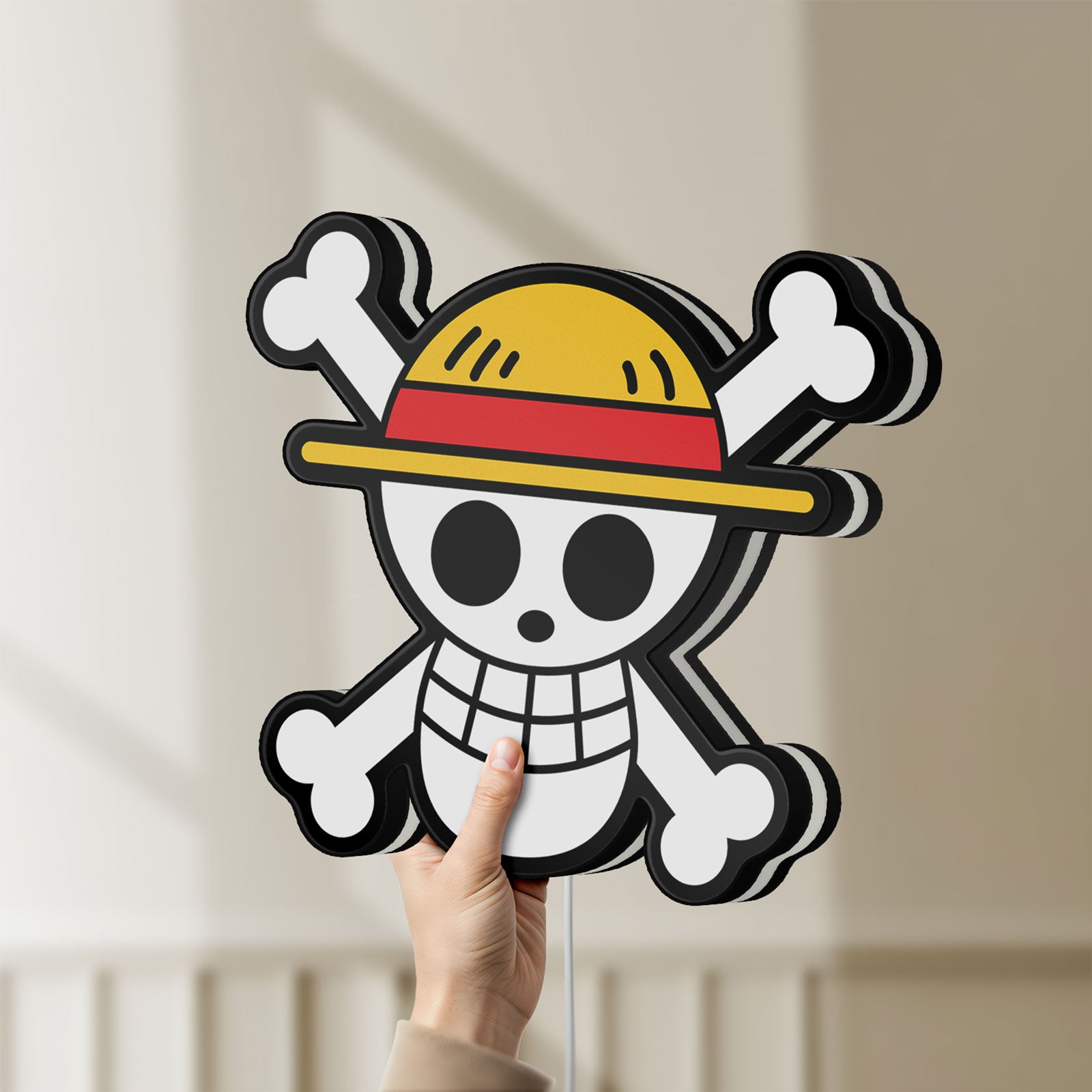 Unlit One Piece Skull LED lightbox held by hand to show size and details