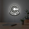 Capsule Corp LED lightbox hanging on a room wall with soft white light