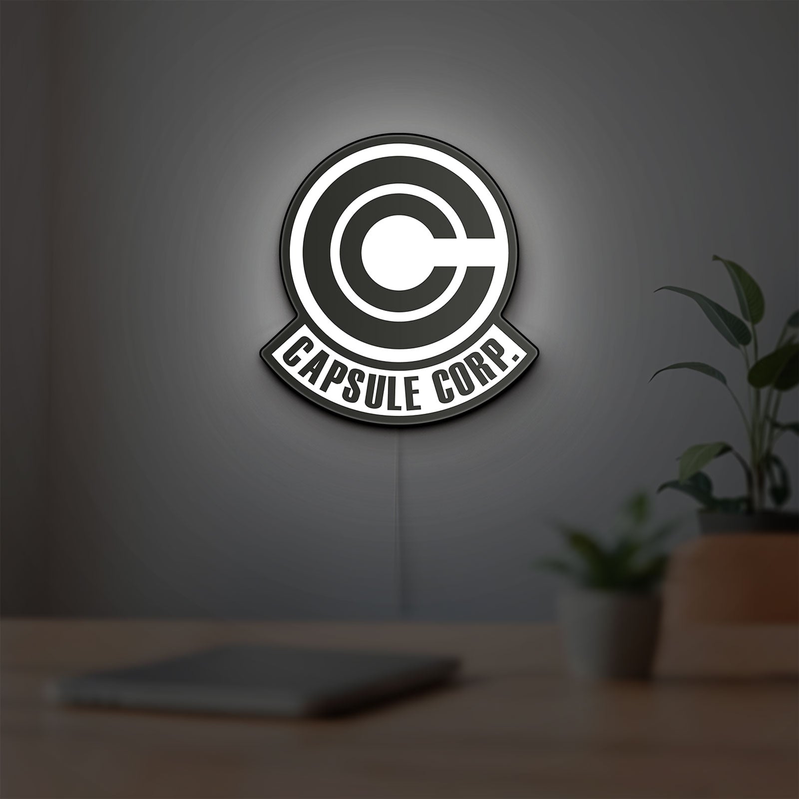 Capsule Corp LED lightbox hanging on a room wall with soft white light