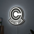 Capsule Corp LED lightbox hanging on a wall with white glow