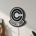 Unlit Capsule Corp LED lightbox mounted on a wall in daylight
