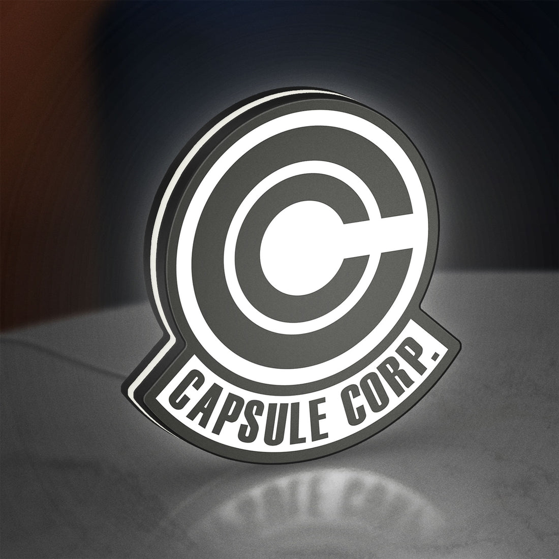 Capsule Corp LED lightbox hanging on a wall with white glow