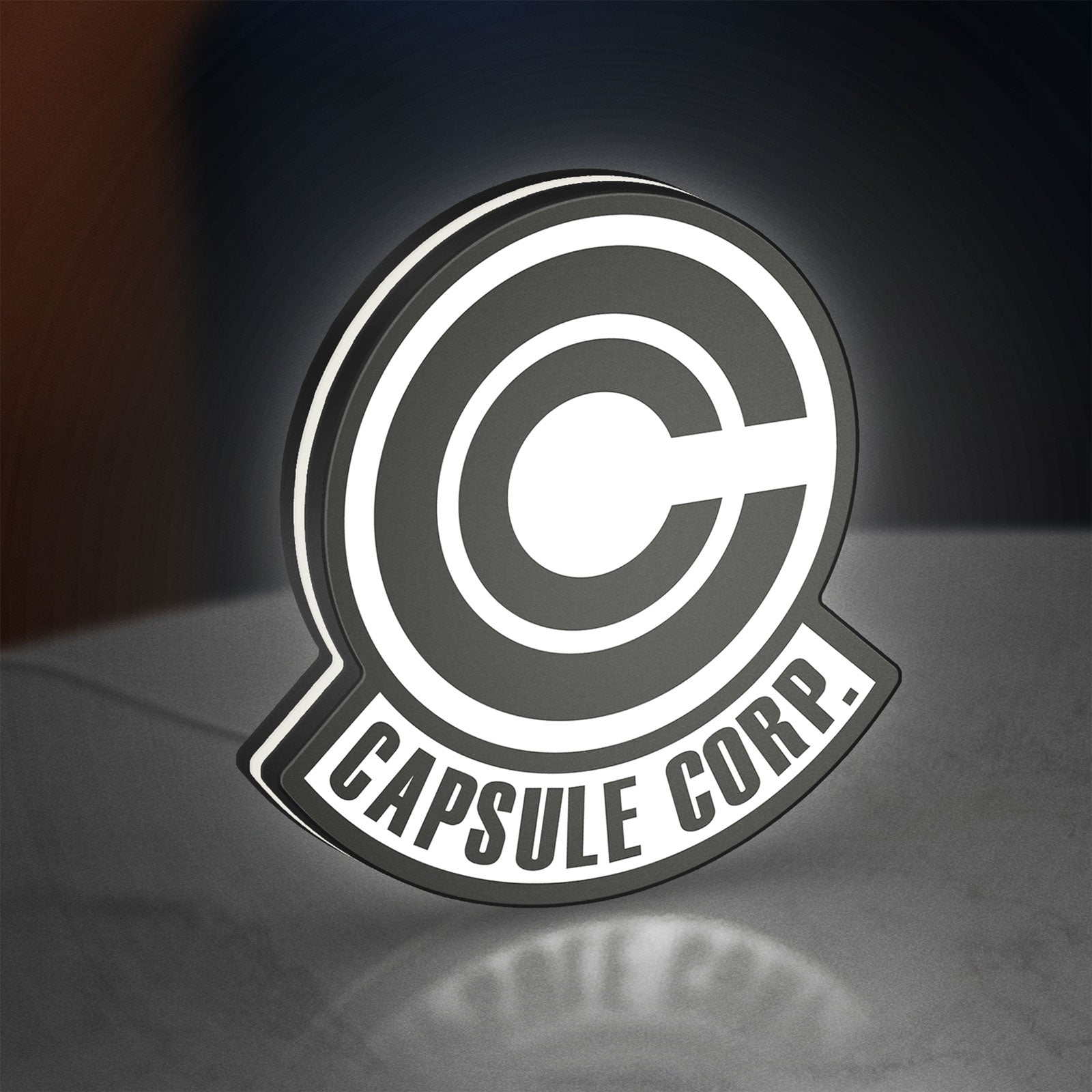 Capsule Corp LED lightbox standing on a desk from an angled side view with white glow