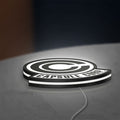 Capsule Corp LED lightbox lying flat on a desk with white glow