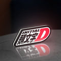 Initial D LED lightbox standing on a desk from an angled side view with white glow