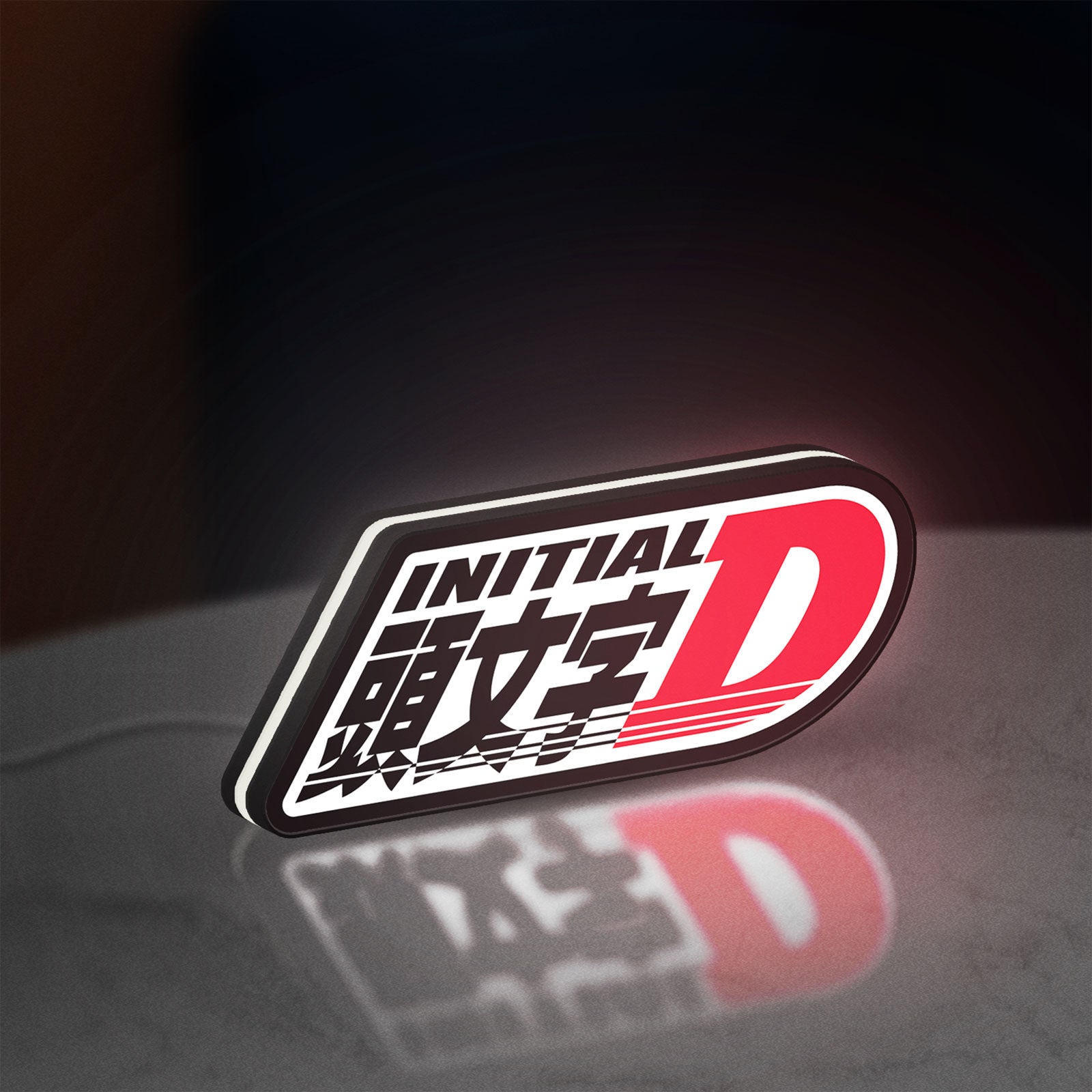 Initial D LED lightbox standing on a desk from an angled side view with white glow