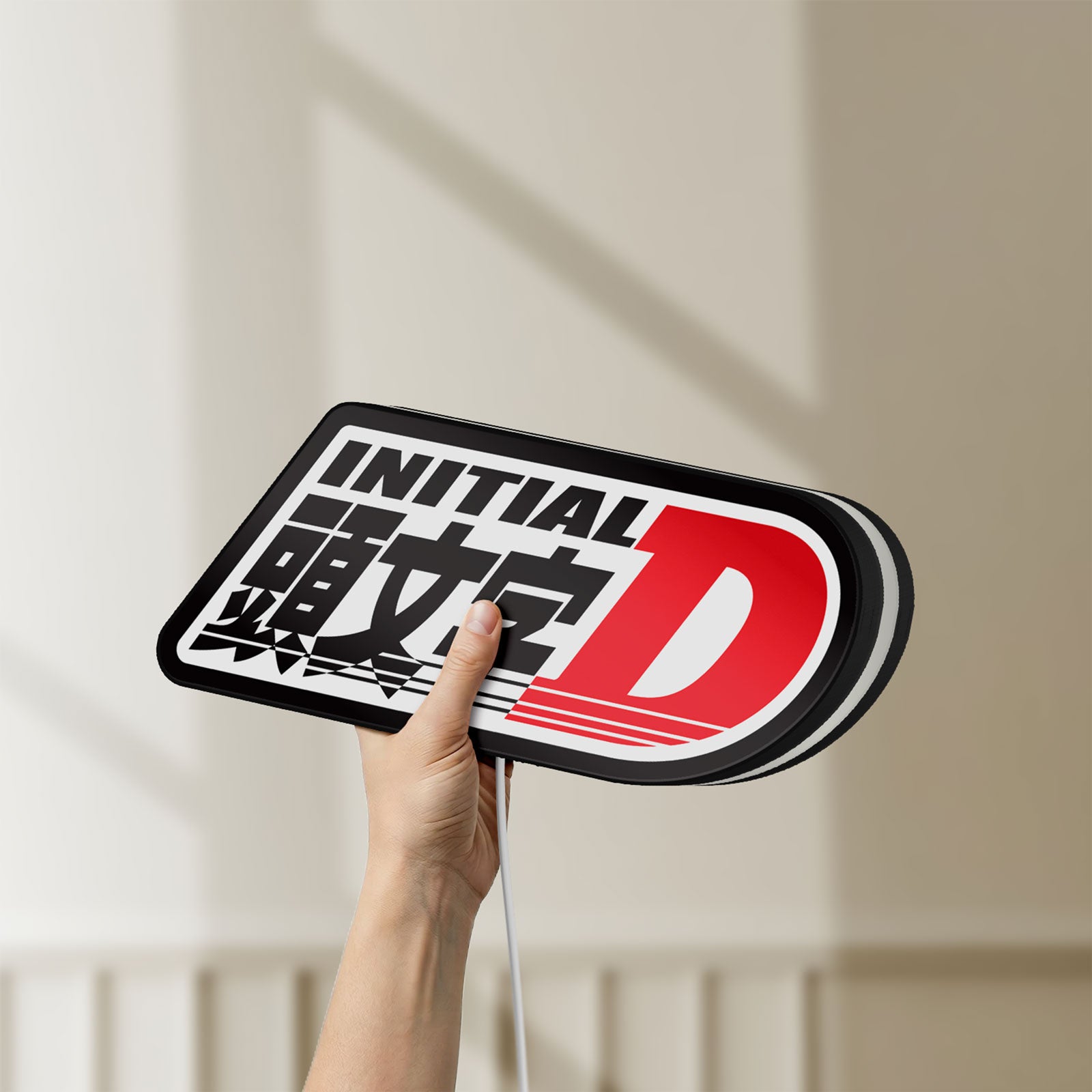 Unlit Initial D LED lightbox held by hand to show size and details