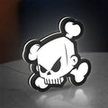 Ken Block Skull LED lightbox standing on a desk from an angled side view with white glow