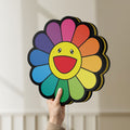 Unlit Takashi Murakami Rainbow Flower LED lightbox held by hand to show size and details
