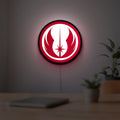 Jedi Order LED lightbox hanging on a room wall with soft red light