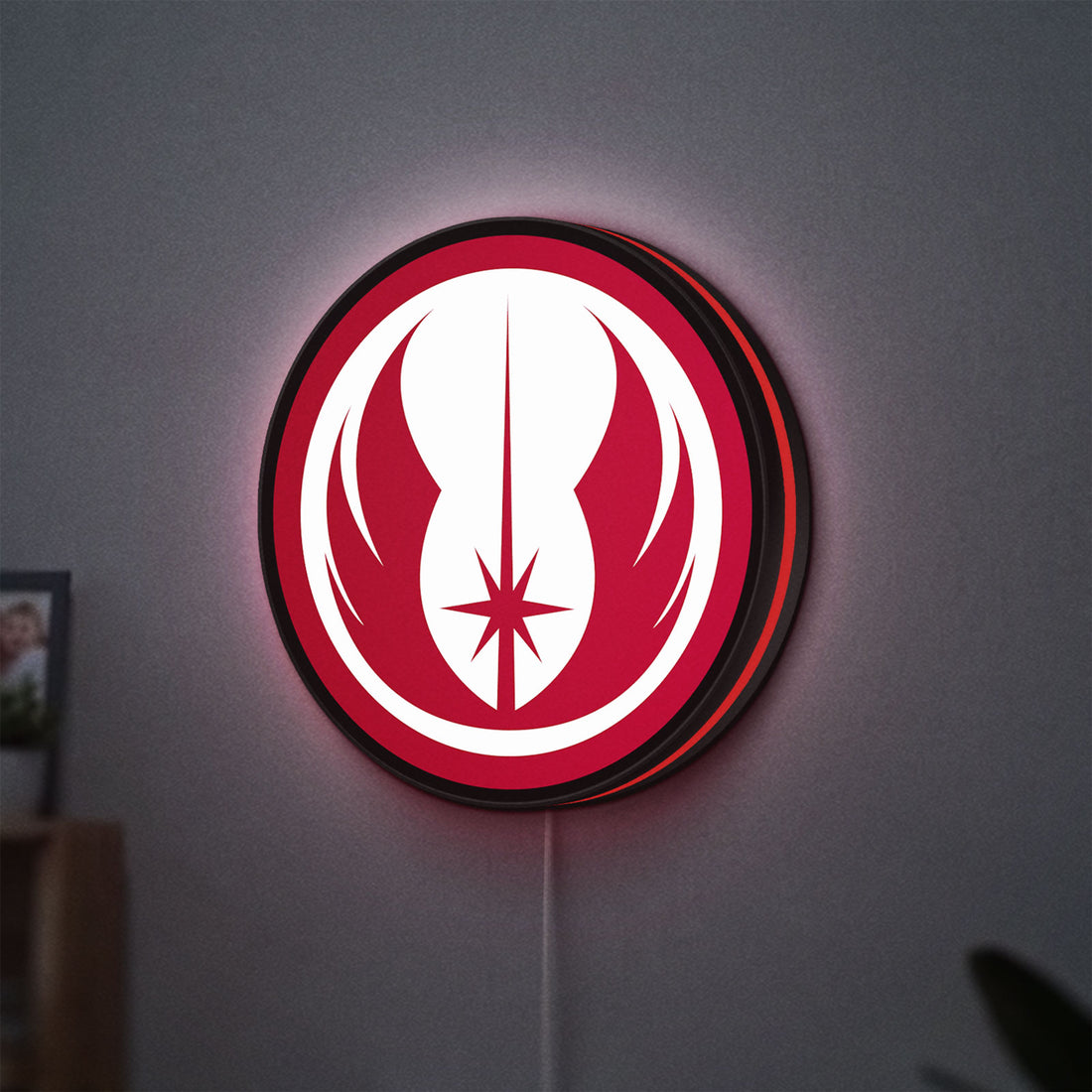 Jedi Order LED lightbox hanging on a wall with red glow