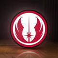 Front view of Jedi Order LED lightbox sign glowing on a wooden desk