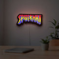 Spider-Man LED lightbox hanging on a room wall with soft yellow light