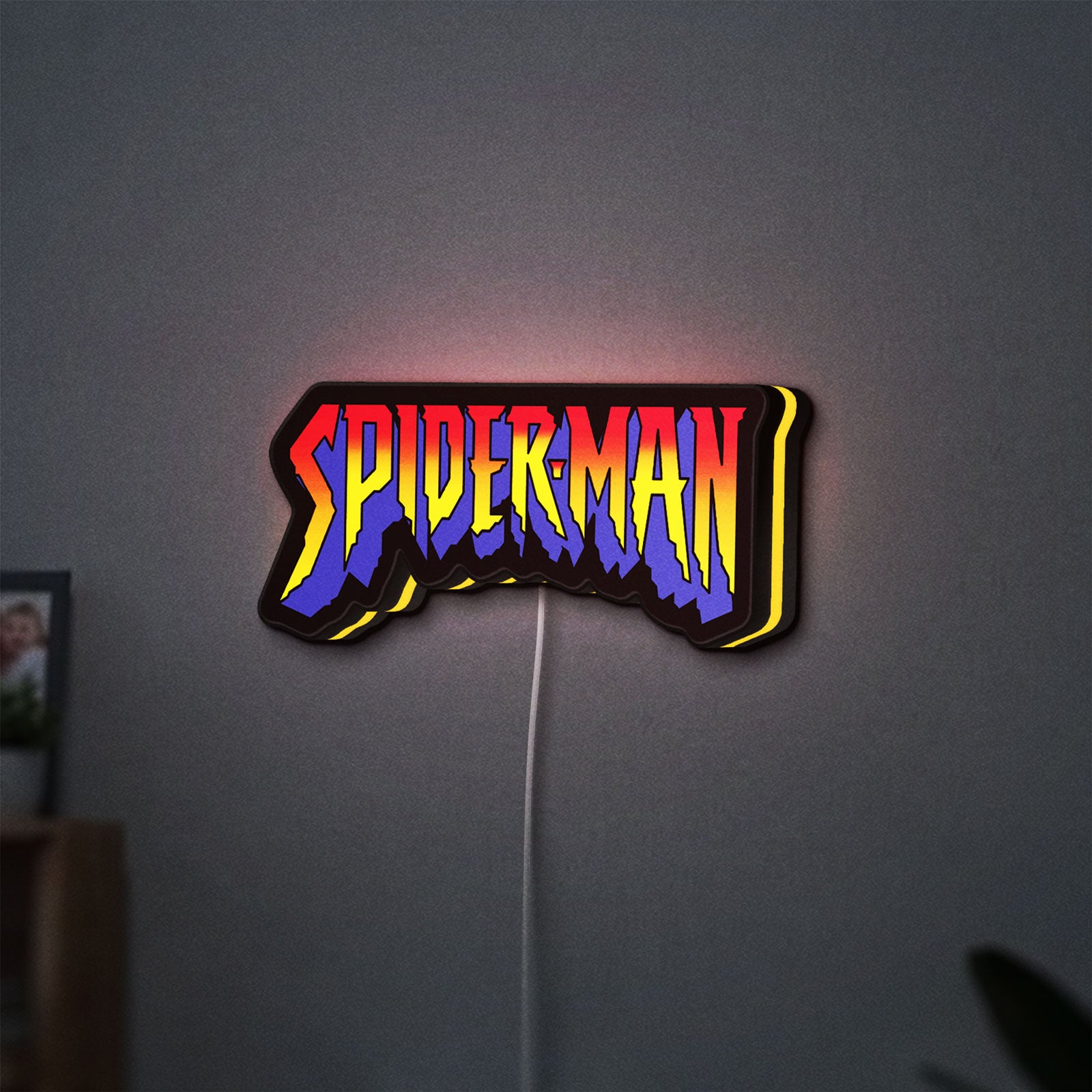 Spider-Man LED lightbox hanging on a wall with yellow glow