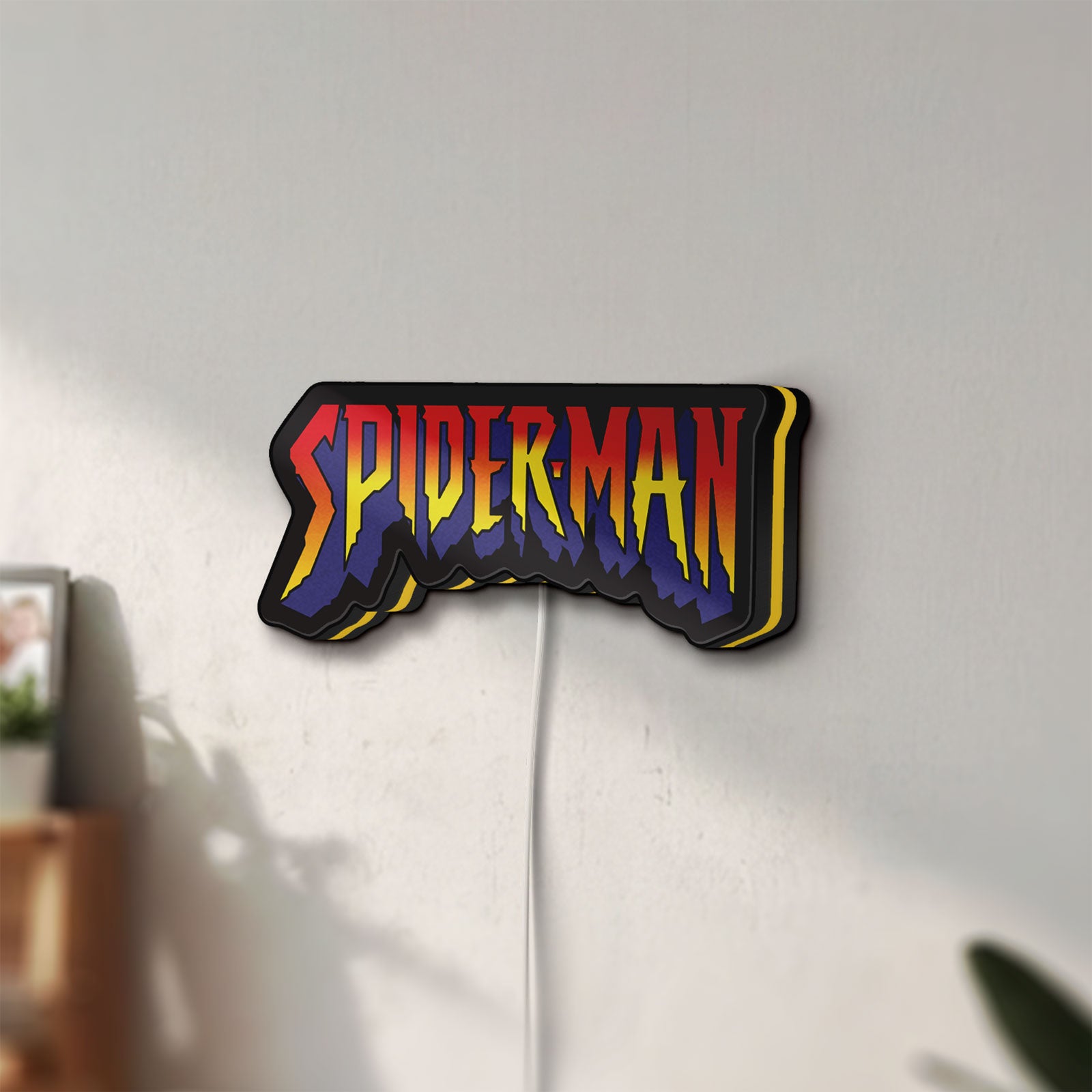 Unlit Spider-Man LED lightbox mounted on a wall in daylight