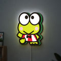 Keroppi LED lightbox hanging on a wall with green glow