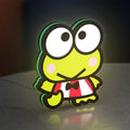 Keroppi LED lightbox standing on a desk from an angled side view with green glow
