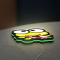 Keroppi LED lightbox lying flat on a desk with green glow