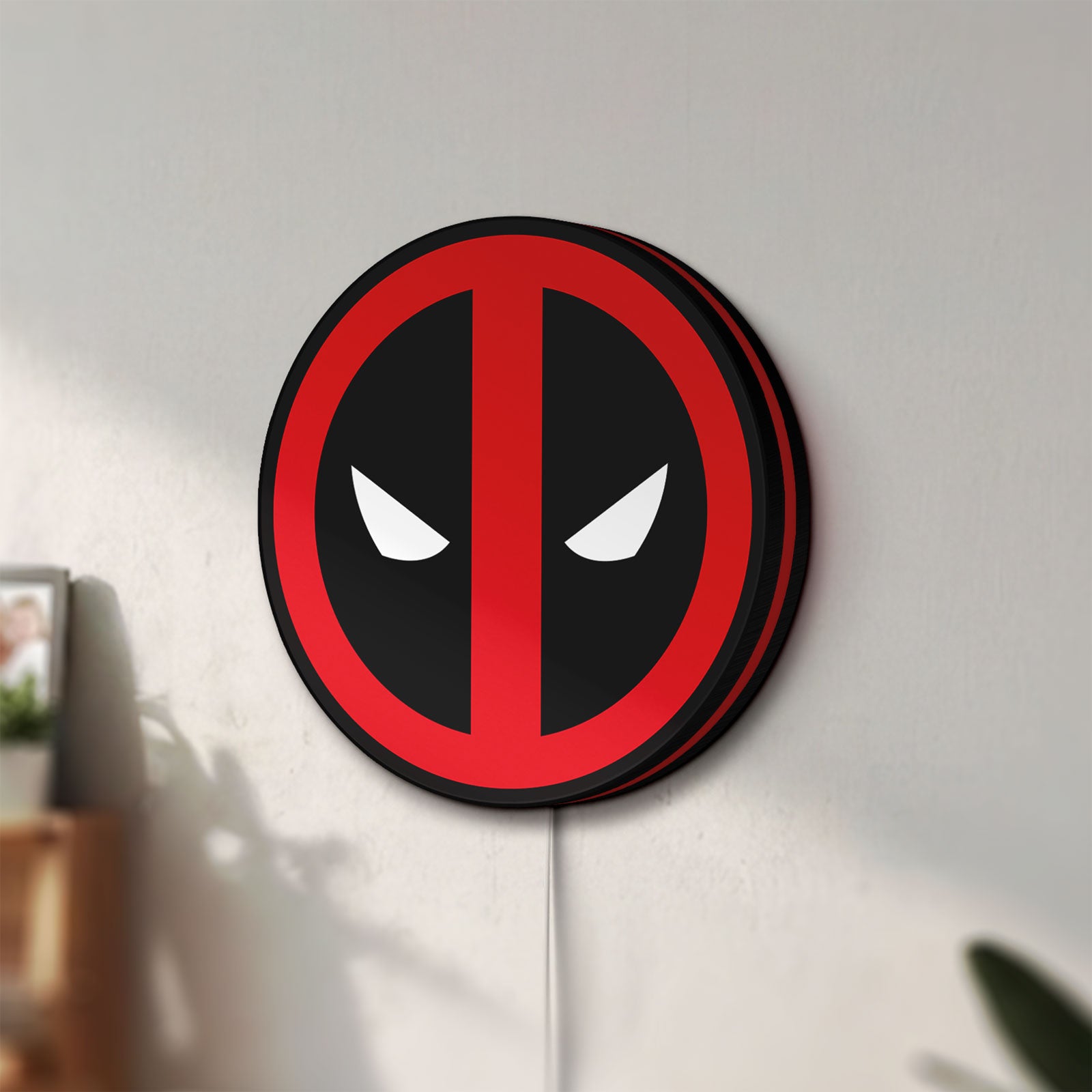 Unlit Deadpool LED lightbox mounted on a wall in daylight