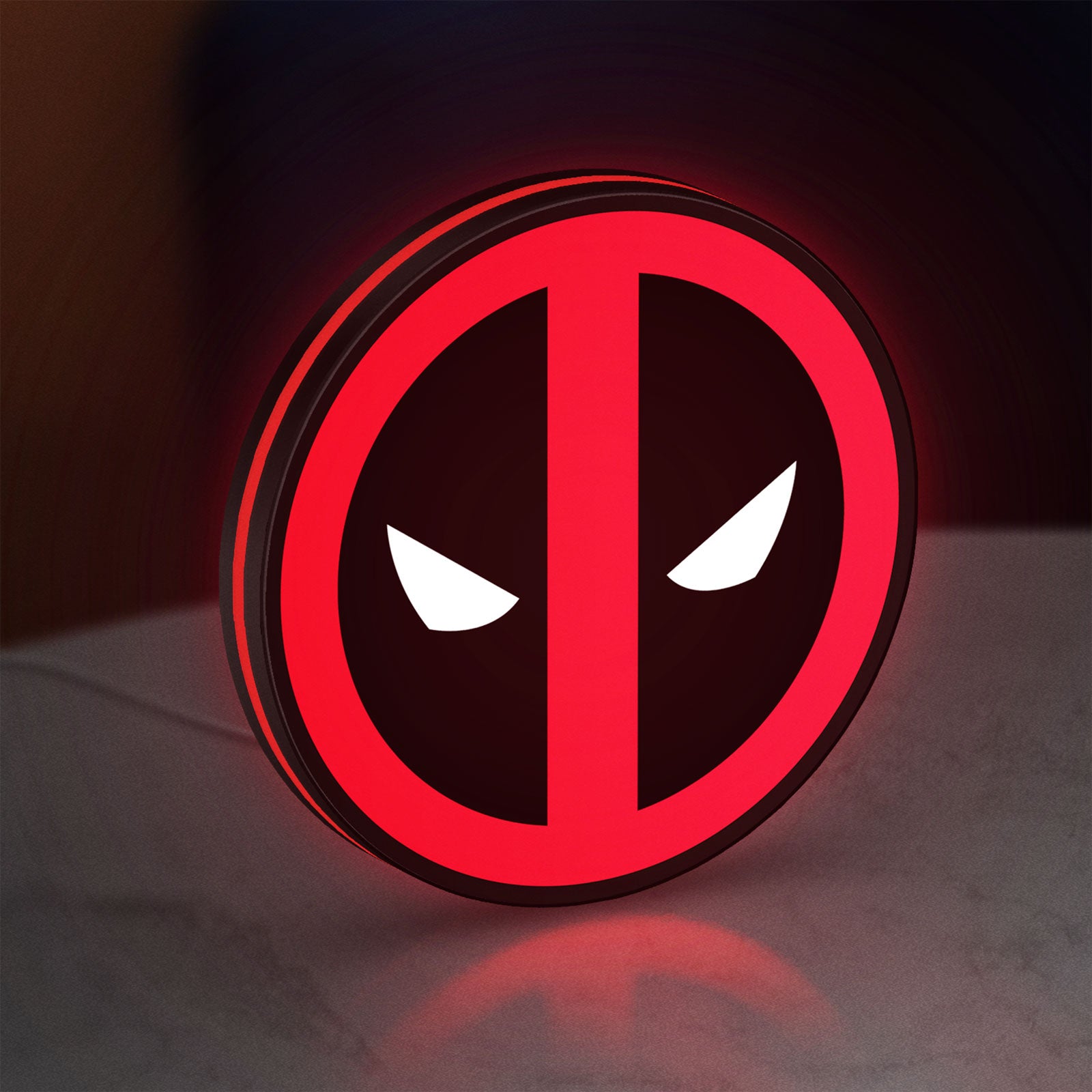 Deadpool LED lightbox standing on a desk from an angled side view with red glow