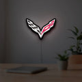 Corvette LED lightbox hanging on a room wall with soft white light