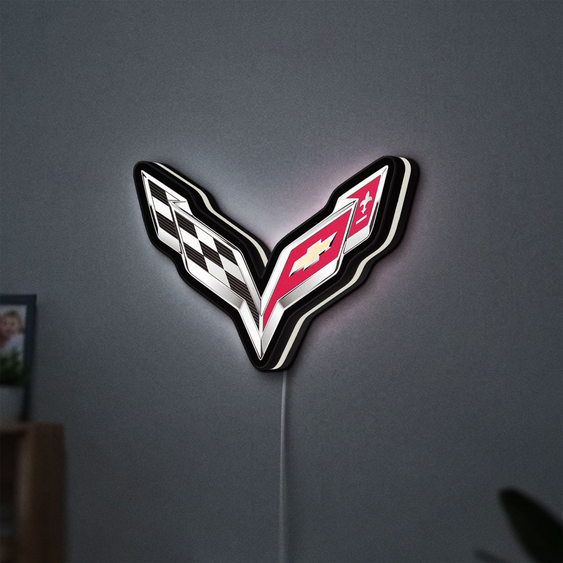 Corvette LED lightbox hanging on a wall with white glow