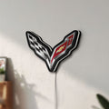 Unlit Corvette LED lightbox mounted on a wall in daylight