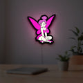 Tinkerbell LED lightbox hanging on a room wall with soft pink light