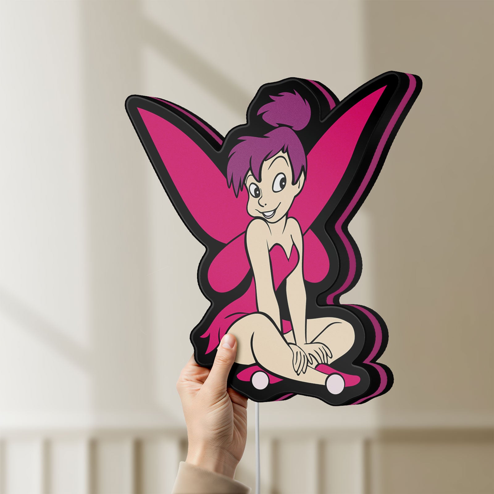 Unlit Tinkerbell LED lightbox held by hand to show size and details