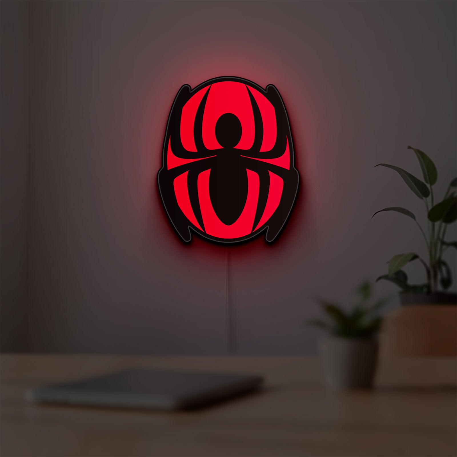 Spider-Man LED lightbox hanging on a room wall with soft red light