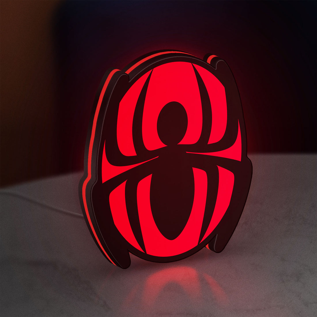 Spider-Man LED lightbox hanging on a wall with red glow